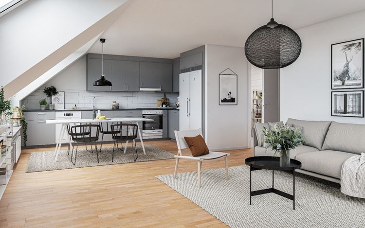 Torghusen Fyllinge. Ett stilrent kök i ljusgrått och vitt i öppen planlösning med plats för både matbord och soffa. 