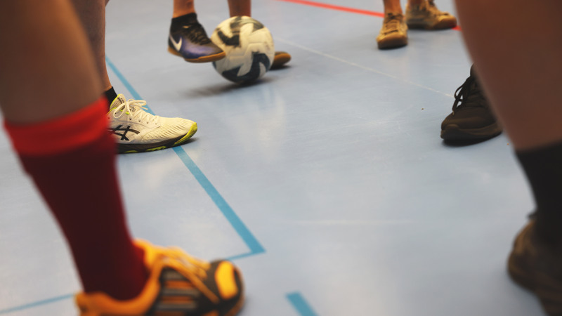 En grupp människor som står på ett blått golv.