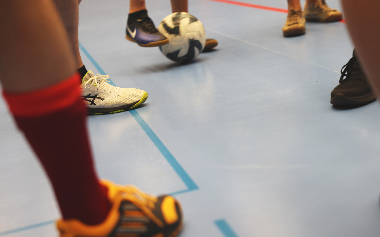 En grupp människor som står på ett blått golv.